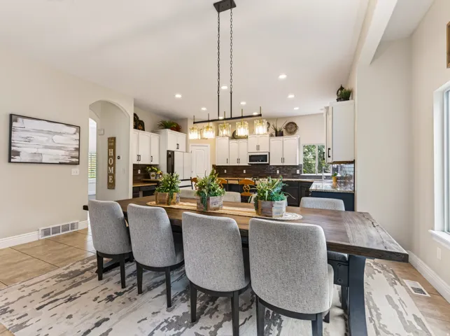 Recessed lighting, wood-finish flooring, and arched doorways