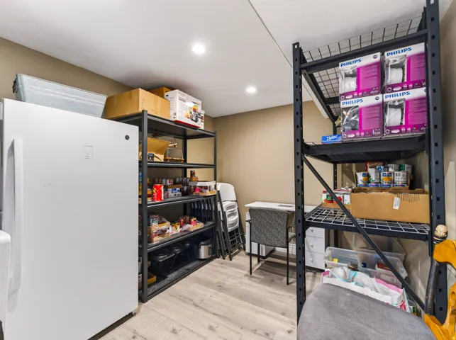 Recessed ceiling lighting, wood-finish flooring, and painted walls