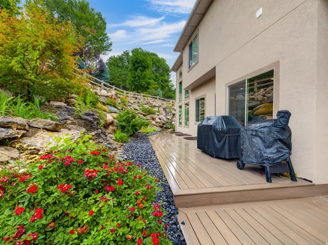 Expansive wood-finish deck with stucco exterior