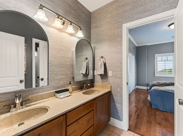 Dual arched mirrors over a dual vanity with integrated sinks