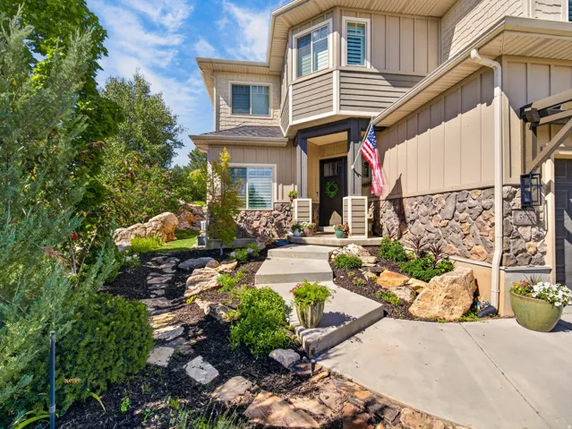 Exterior featuring stone veneer and horizontal siding