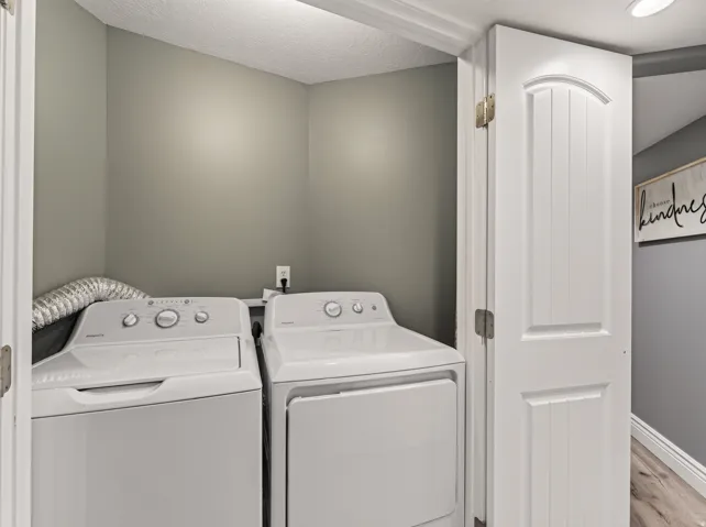 Dedicated laundry area with neutral wall color and an interior panel door