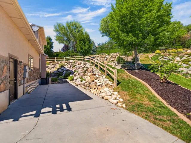 Concrete paved area with a stone veneer exterior accent