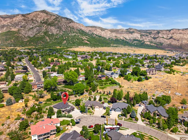 Aerial perspective showcasing a residential neighborhood with mountain backdrop