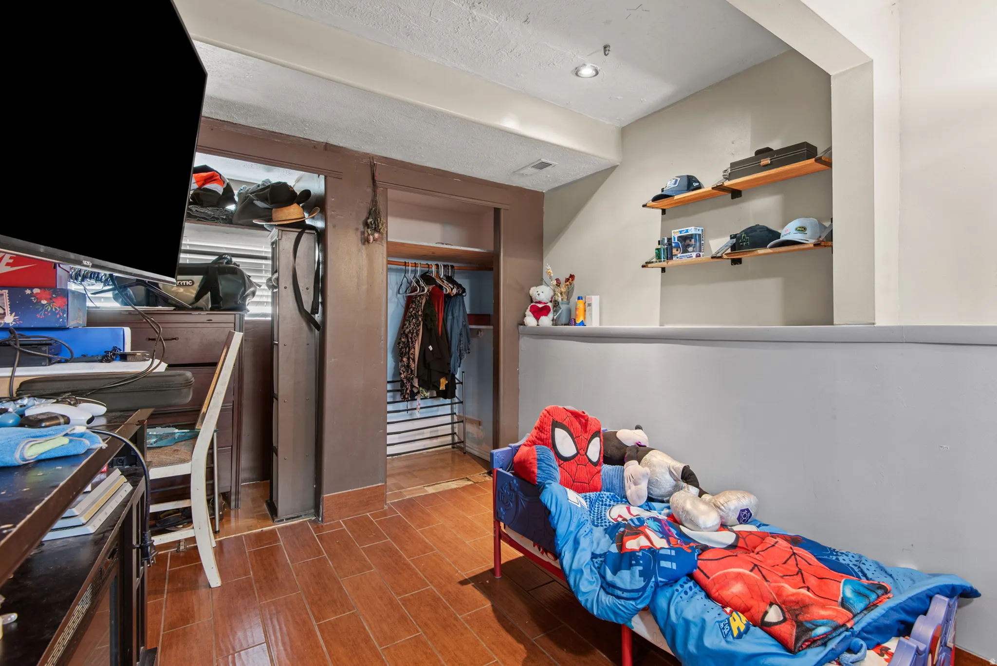 Wood-finish flooring, recessed lighting, and built-in shelving