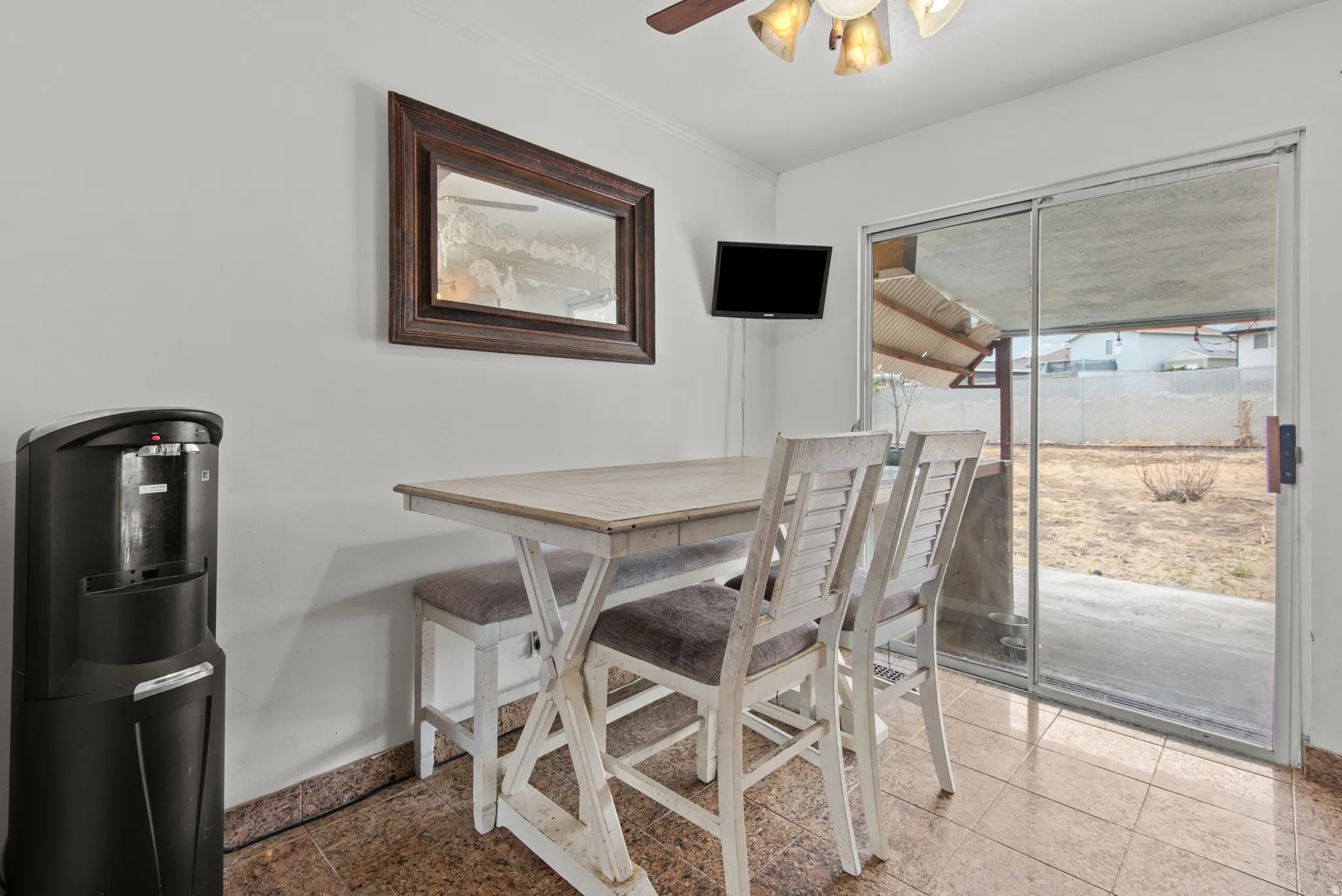 Sliding glass door access to the exterior, with tile flooring throughout