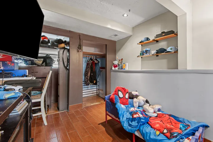 Wood-finish flooring, recessed lighting, and built-in shelving