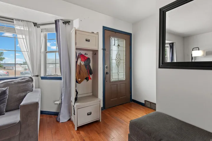 Entryway featuring wood-finish flooring and a decorative glass-paneled entry door