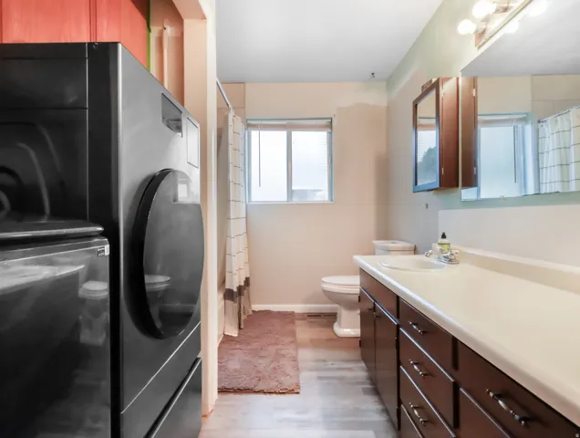 Integrated laundry appliances and wood-finish flooring
