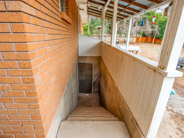 Brick exterior wall with a concrete foundation and basement access