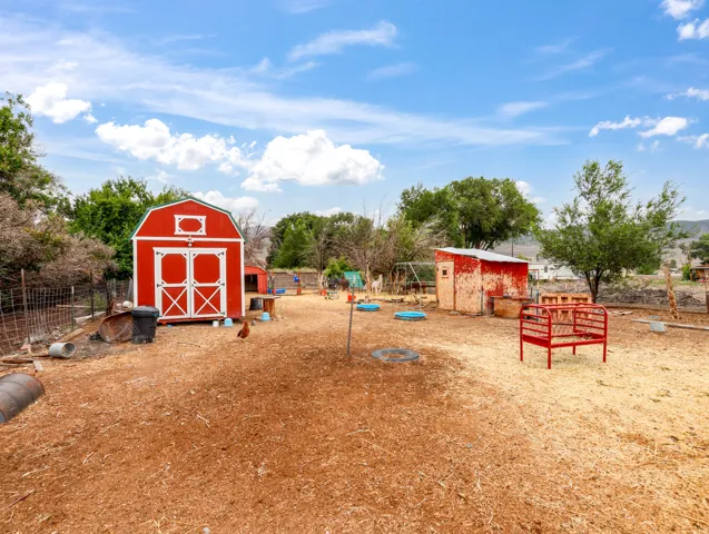 Red barn-style shed with white trim and double doors