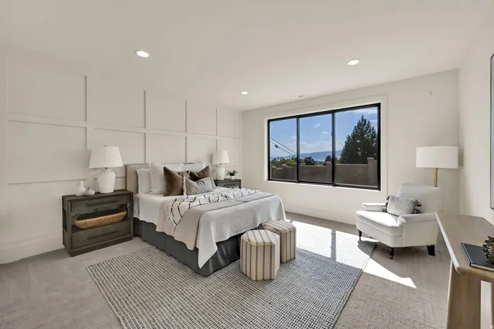 Board and batten wall detailing, large picture window, recessed lighting, and carpeted flooring