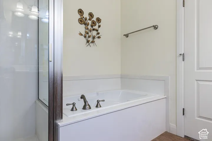 Built-in soaking tub with deck-mounted bronze-finish fixtures