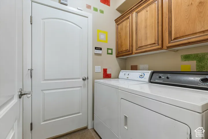 Wood-finish cabinetry, neutral wall paint, and white paneled doors