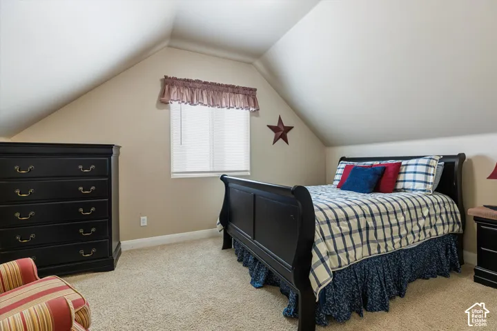 Vaulted ceilings accent a neutral color palette and plush carpet flooring