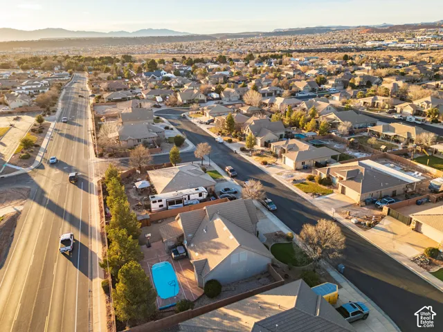 Neighborhood setting with residential properties, paved streets, and distant mountain backdrop