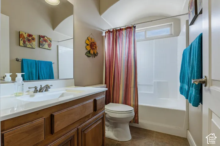 Vanity with wood-finish cabinetry, integrated sink, and brushed nickel faucet
