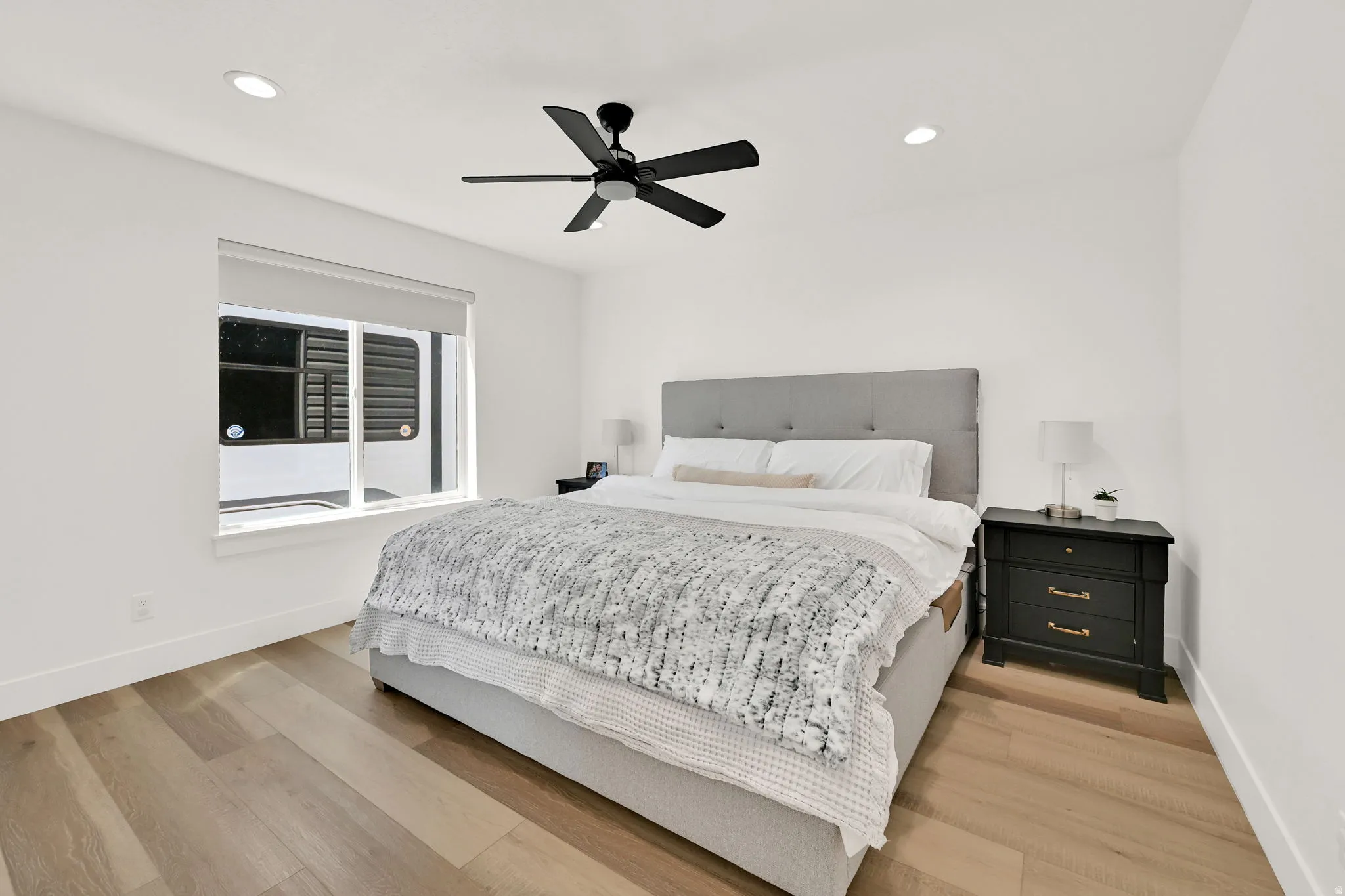 Wood-finish flooring, recessed lighting, and a modern ceiling fan