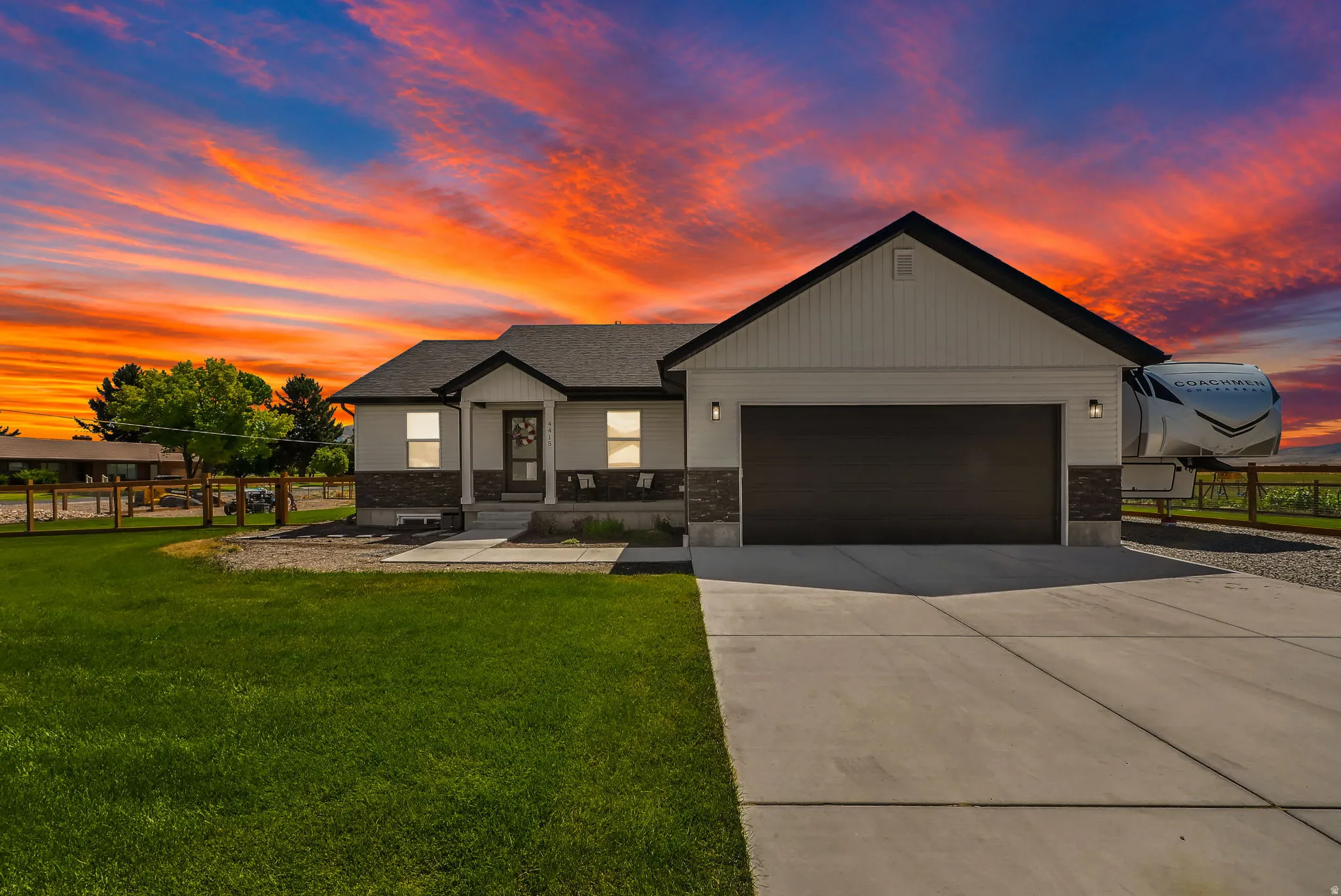 Contemporary exterior with white siding and stone accents