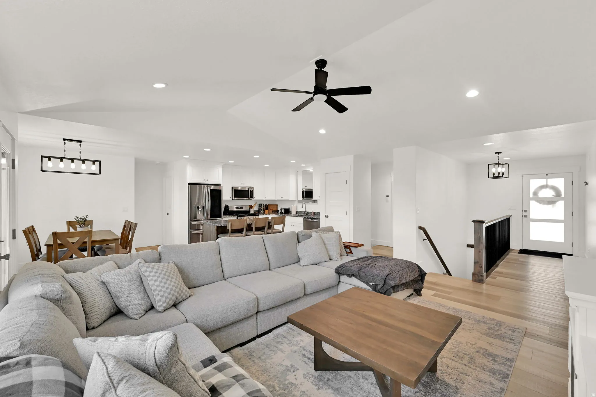 Open-concept living area with light-toned wood-finish flooring