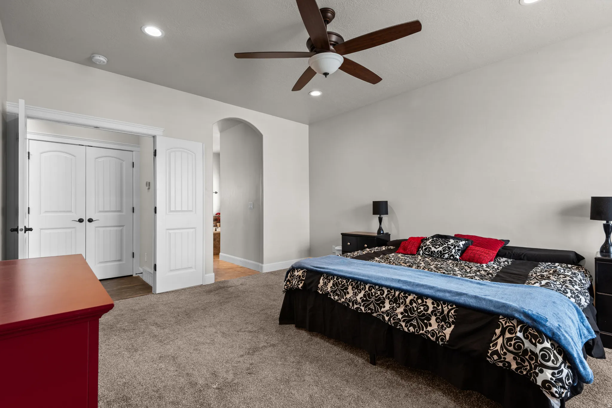 Recessed lighting, ceiling fan with light fixture, arched doorway, and white paneled doors