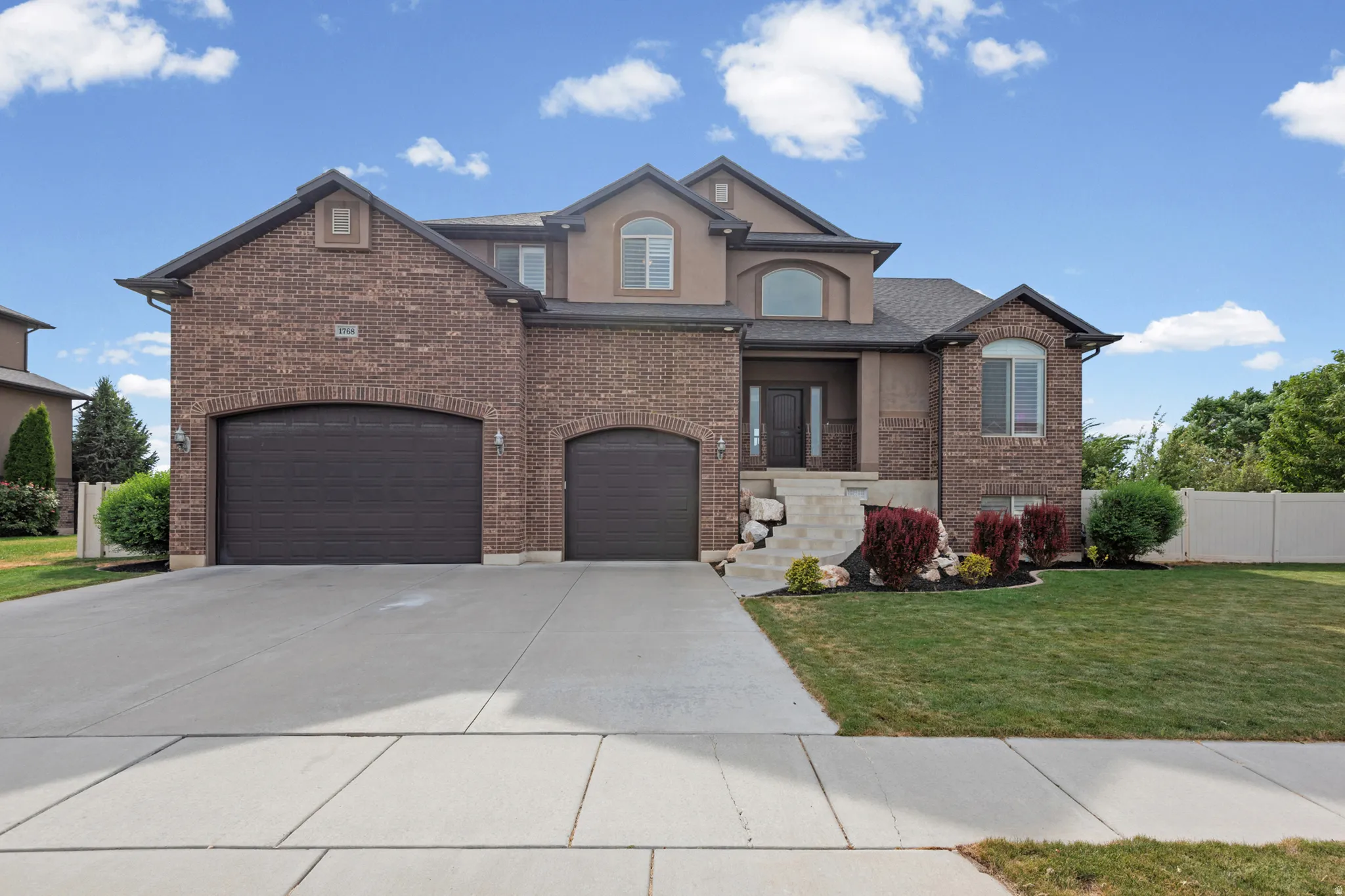 Brick and stucco exterior with multiple gables