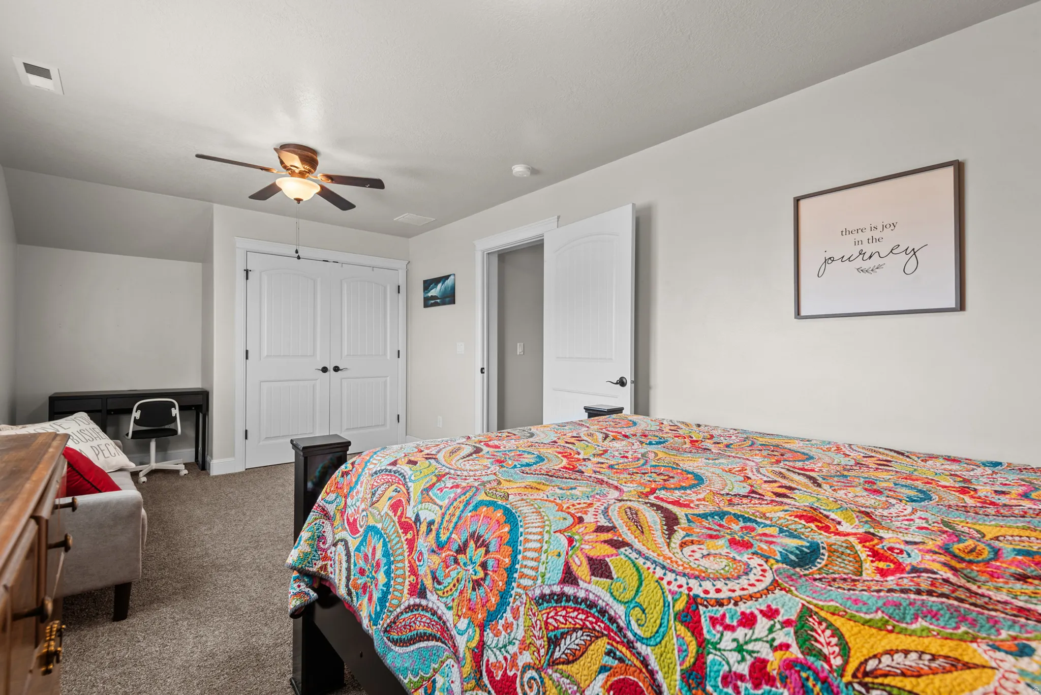 Carpet flooring, white paneled doors, and a ceiling fan with integrated lighting