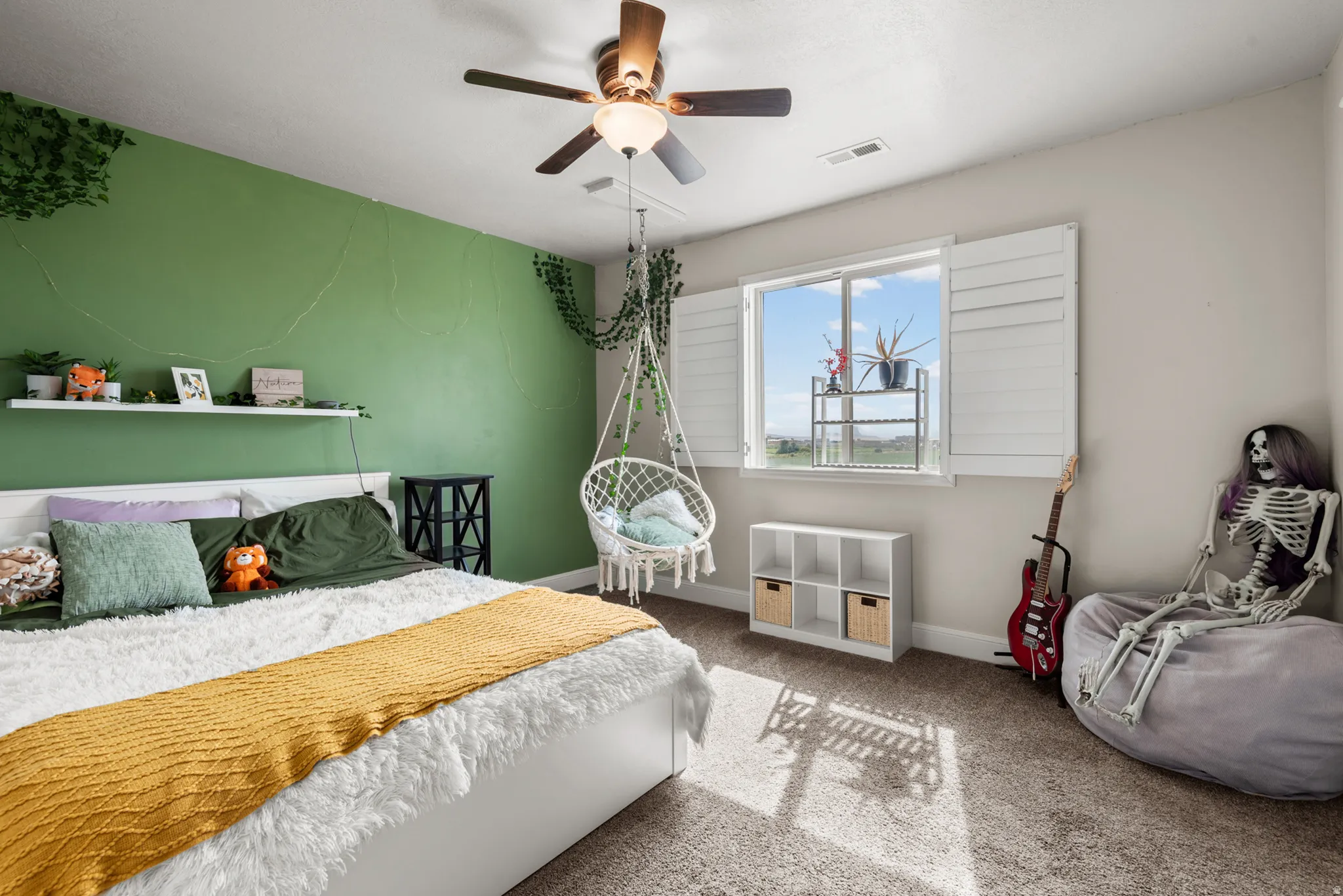 Recessed lighting, ceiling fan, carpeted flooring, wall-mounted shelving, and a double-pane window with plantation shutters