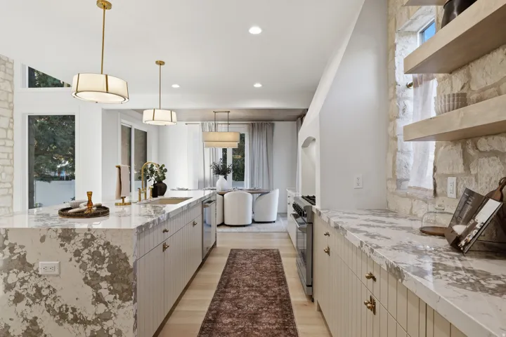 Waterfall island with a built-in sink and gold-finish faucet