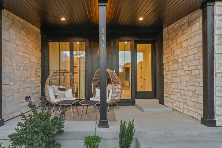 Stone veneer exterior with dark wood-finish paneling