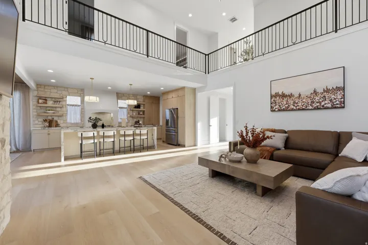 Open-concept living space with light wood-finish flooring