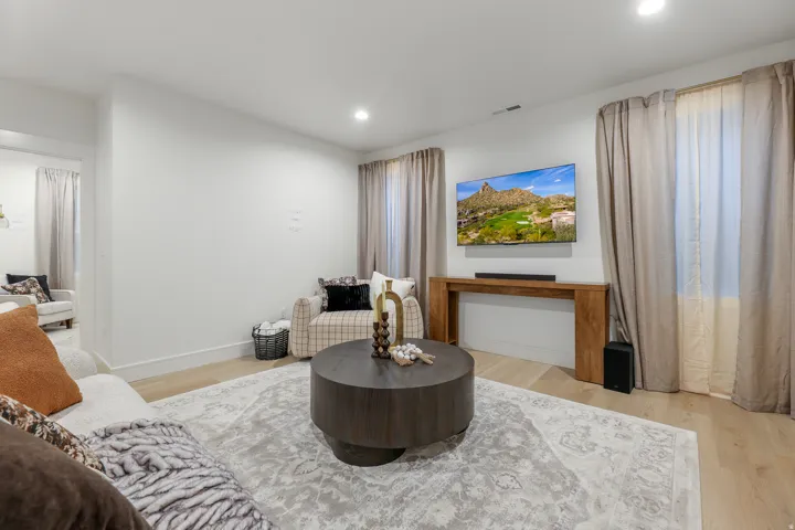 Recessed ceiling lighting, light wood-finish flooring, and crisp white walls