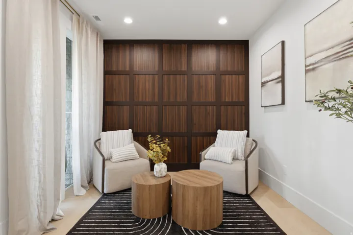 Hardwood flooring paired with a paneled accent wall and recessed lighting