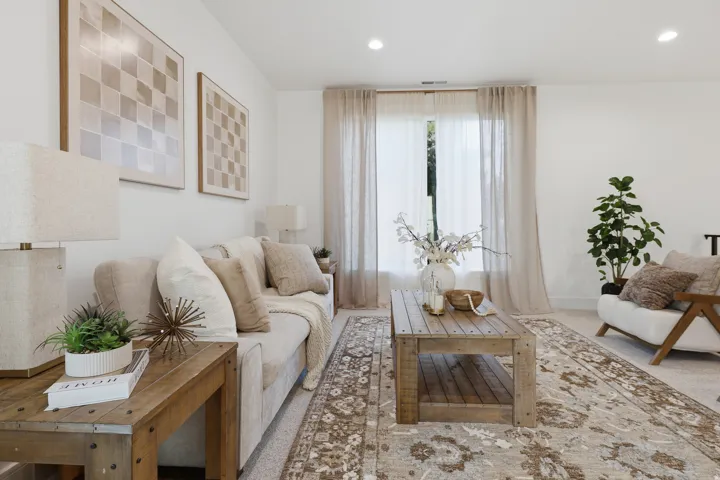 Recessed ceiling lighting, light-toned wall finishes, and a large window with sheer drapery