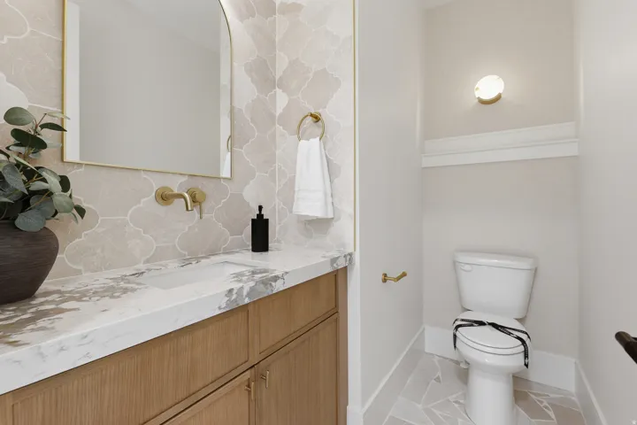Integrated vanity with a rectangular basin, wood-finish cabinetry, and a stone countertop