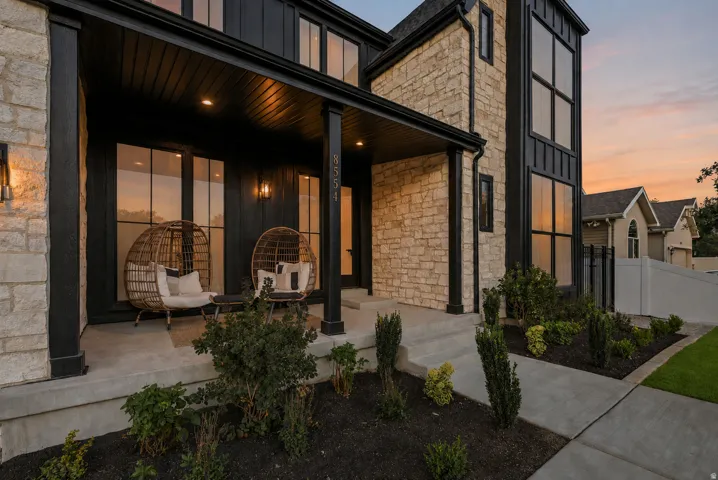 Stone and board-and-batten exterior with a covered porch and concrete steps