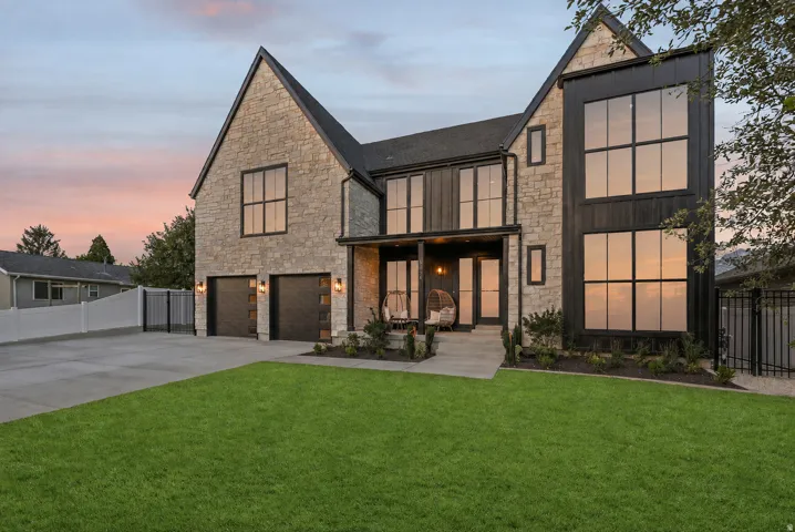 Stone and board-and-batten exterior with an attached two-car garage