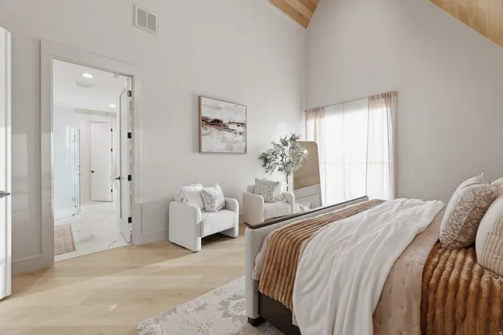 Vaulted wood-paneled ceiling, light wood-finish flooring, and white walls