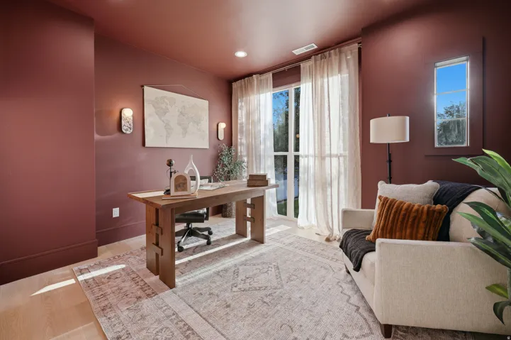 Hardwood flooring, full-height windows, recessed lighting, and wall sconces