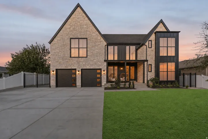 Stone facade with black vertical siding accents