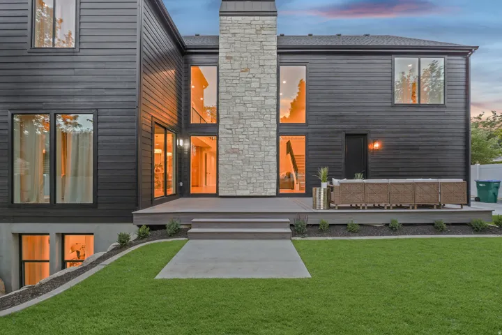 Dark horizontal siding with stone chimney accent