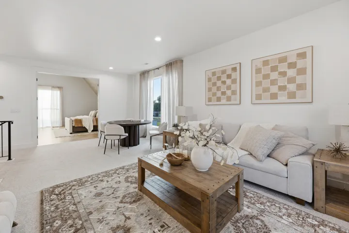 Recessed lighting, light-toned carpeting, wood-finish flooring, and white wall finishes