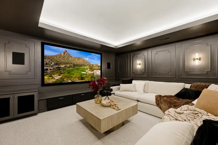 Integrated media screen, recessed lighting, wall sconces, paneled accent wall, built-in cabinetry