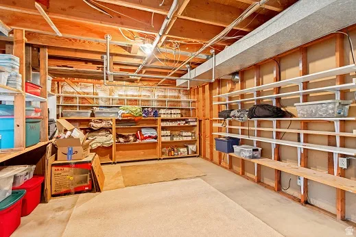 Extensive built-in shelving, concrete flooring, and overhead ductwork