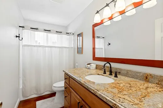Main hall bathroom, granite countertop with undermount sink, bronze-finish faucet, Cherry vanity, tub and newer toilet