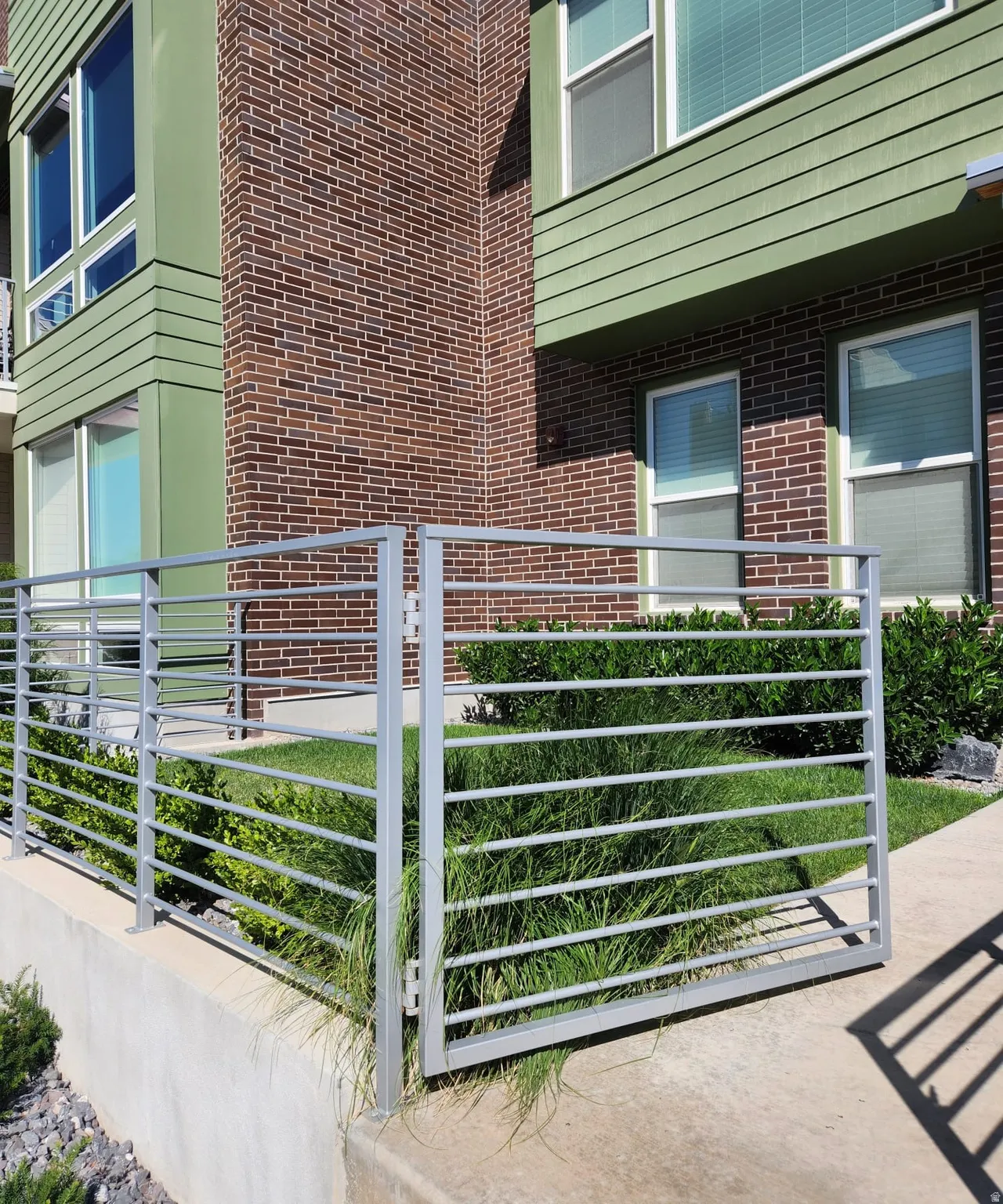 Brick exterior with green horizontal siding accents