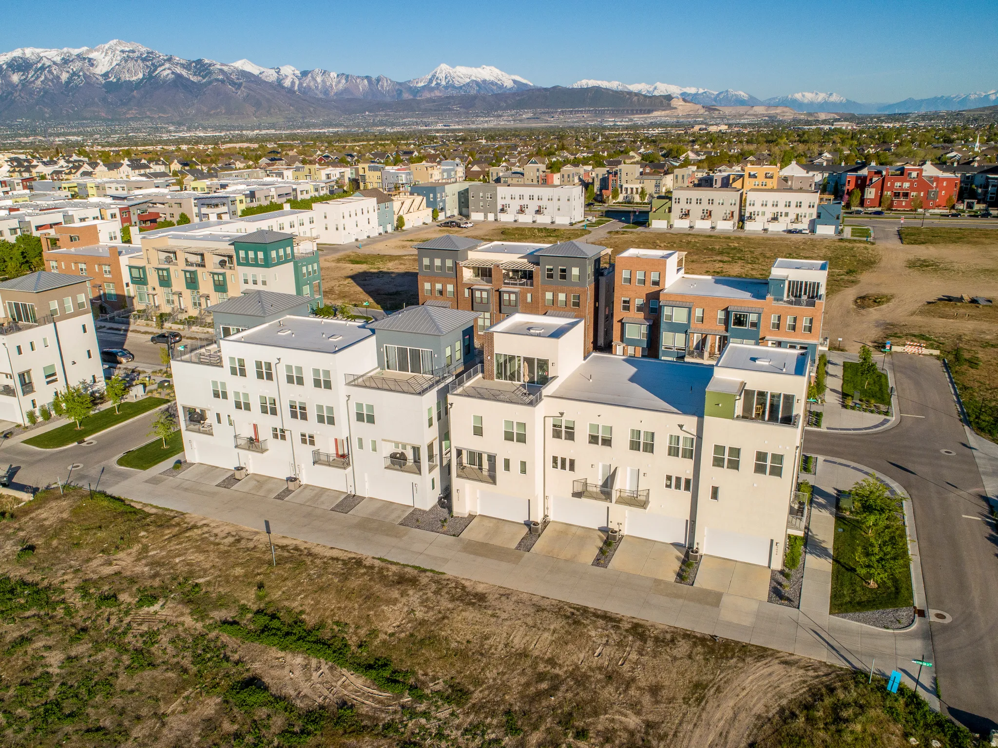 Contemporary townhome-style residences featuring flat roofs and multiple balconies