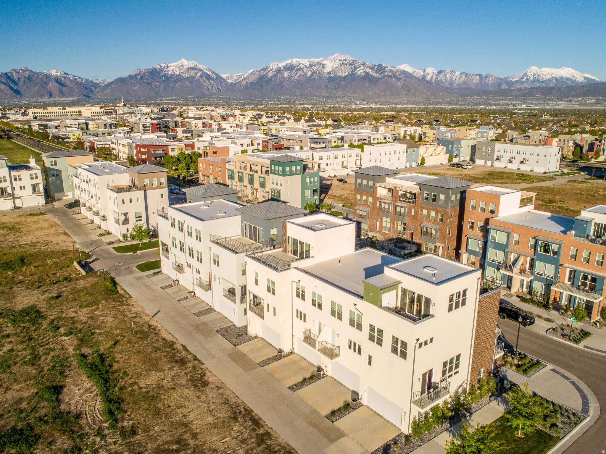 Contemporary multi-story townhome with a flat roofline and integrated garage