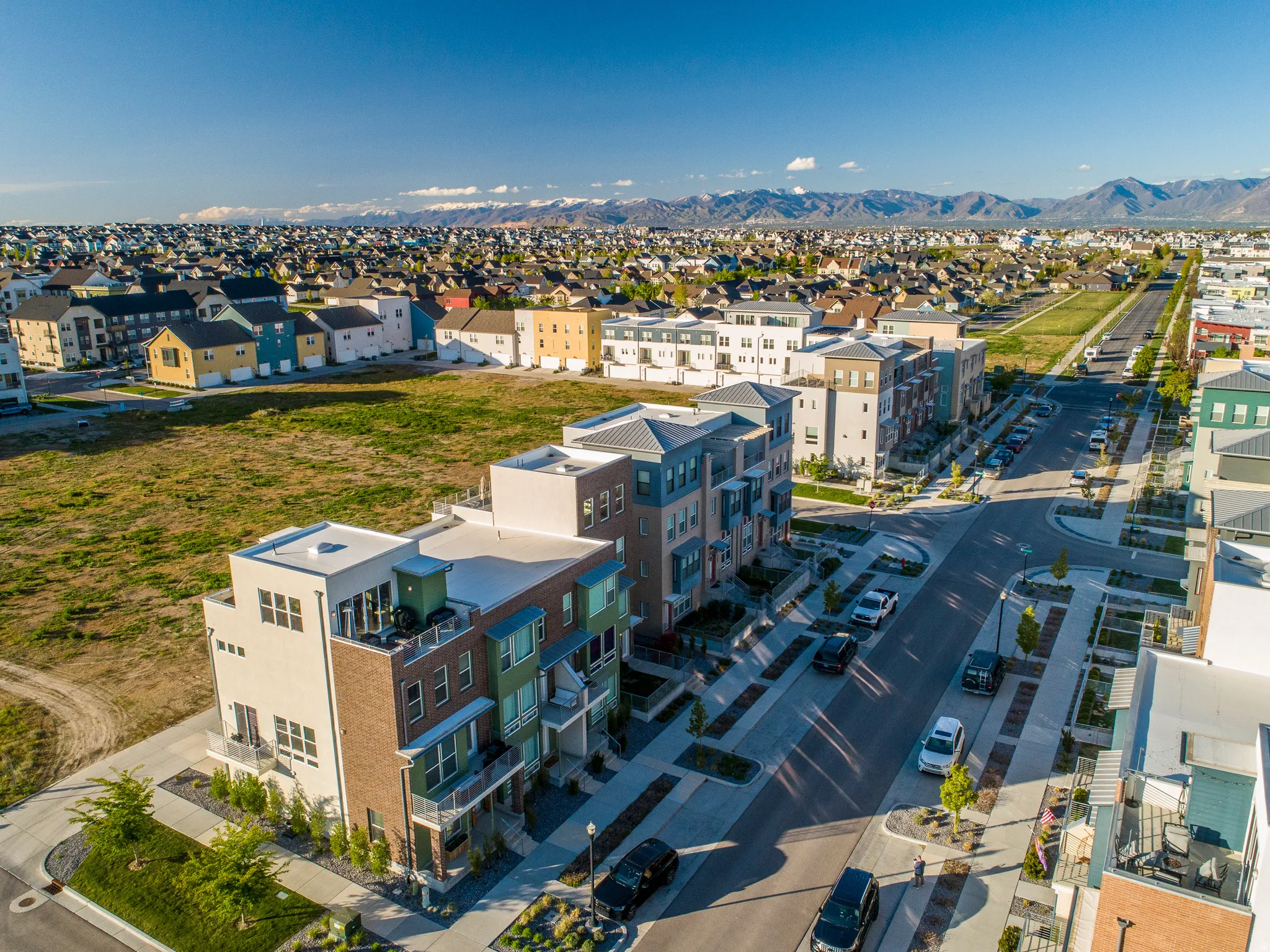 Modern townhome community featuring diverse architectural designs, private balconies, and landscaped common areas