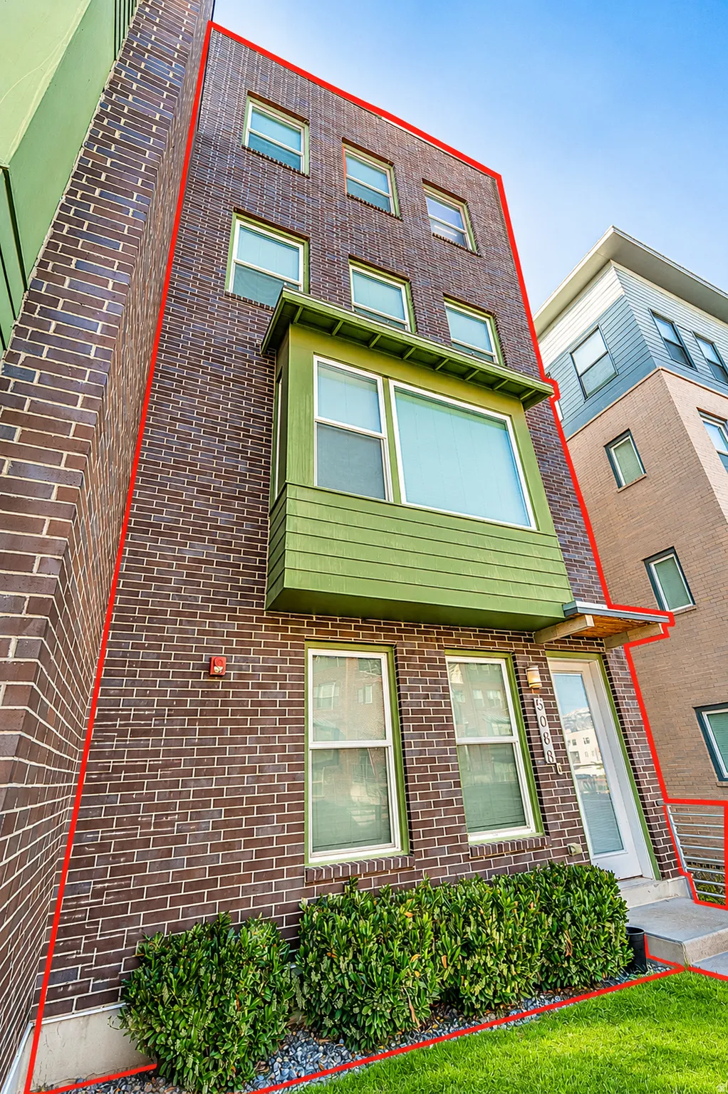 Multi-story brick facade with a prominent bay window